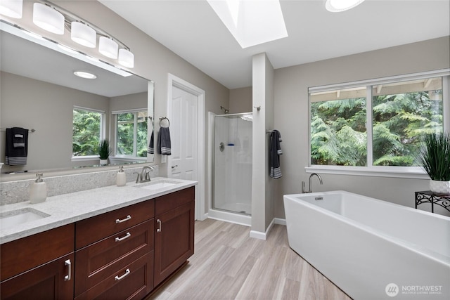 6579 Gleneagle Ave SW, Port Orchard, WA 98367 - bathroom with a stall shower, a skylight, a freestanding tub, and plenty of natural light