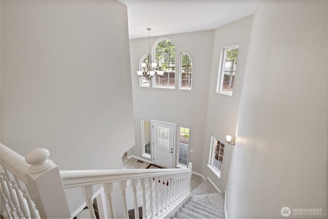 6579 Gleneagle Ave SW, Port Orchard, WA 98367 - stairway with a chandelier and baseboards