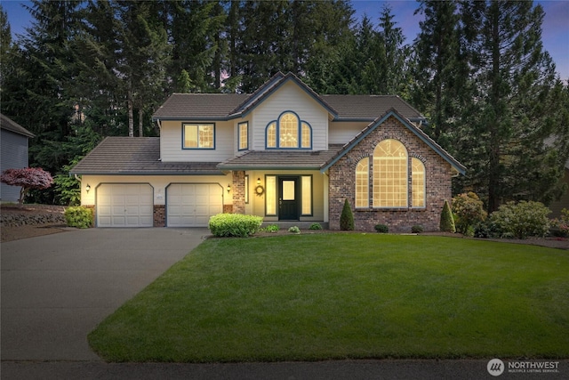 6579 Gleneagle Ave SW, Port Orchard, WA 98367 - traditional home featuring driveway, brick siding, an attached garage, a front yard, and a tile roof