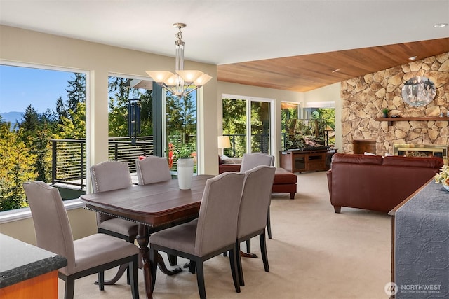 4906 157th Ave SE, Bellevue, WA 98006 - dining area with a chandelier, wood ceiling, light carpet, and a stone fireplace