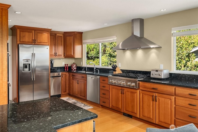 4906 157th Ave SE, Bellevue, WA 98006 - kitchen featuring stainless steel appliances, wall chimney exhaust hood, a sink, light wood-style floors, and brown cabinetry