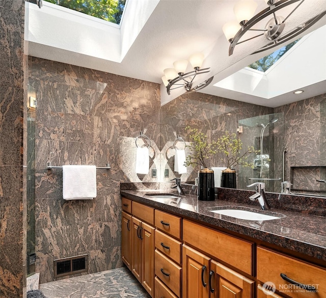4906 157th Ave SE, Bellevue, WA 98006 - full bathroom featuring a skylight, a shower with shower door, double vanity, and plenty of natural light