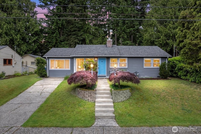 14817 Fremont Ave N, Shoreline, WA 98133 - view of front facade featuring a chimney, a front yard, driveway, and roof with shingles