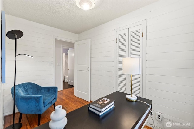 14817 Fremont Ave N, Shoreline, WA 98133 - home office with wood finished floors, a textured ceiling, and wooden walls