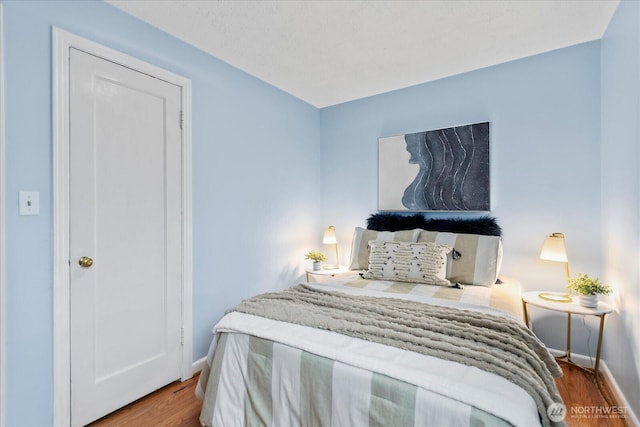 14817 Fremont Ave N, Shoreline, WA 98133 - bedroom featuring baseboards and wood finished floors