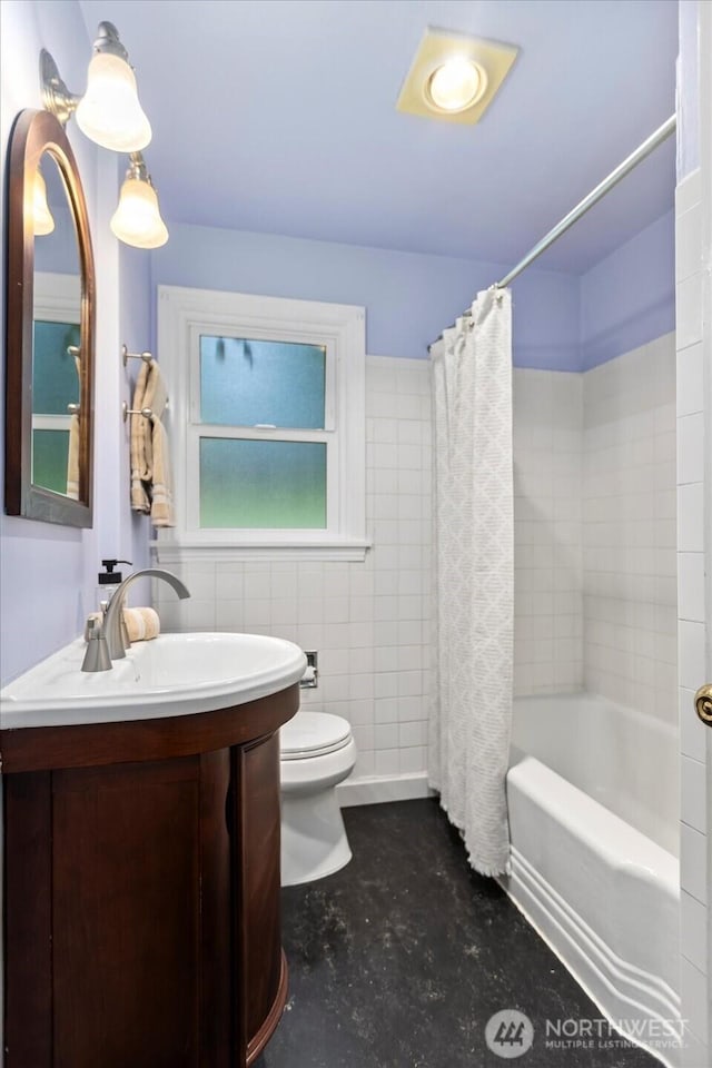 14817 Fremont Ave N, Shoreline, WA 98133 - full bathroom featuring concrete flooring, toilet, vanity, shower / bath combination with curtain, and tile walls