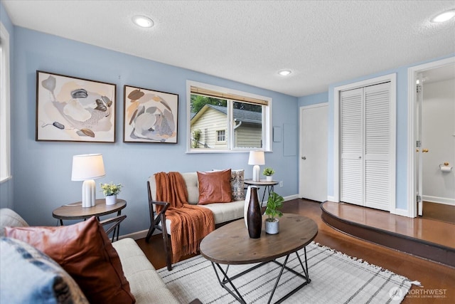 14817 Fremont Ave N, Shoreline, WA 98133 - living area with a textured ceiling, baseboards, recessed lighting, and wood finished floors