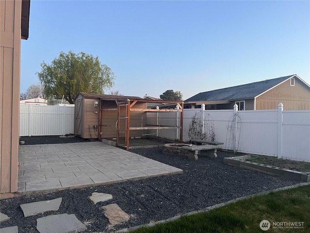 319 N Grape Dr, Moses Lake, WA 98837 - fenced backyard with a patio area and a vegetable garden