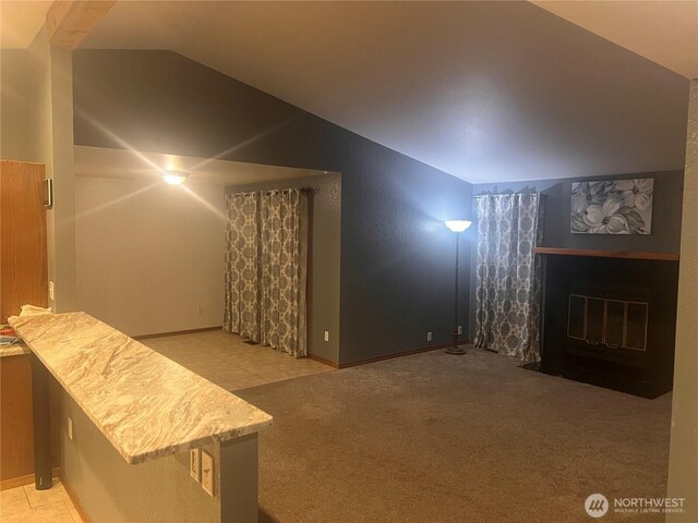 319 N Grape Dr, Moses Lake, WA 98837 - additional living space with lofted ceiling, a fireplace with flush hearth, baseboards, and carpet flooring