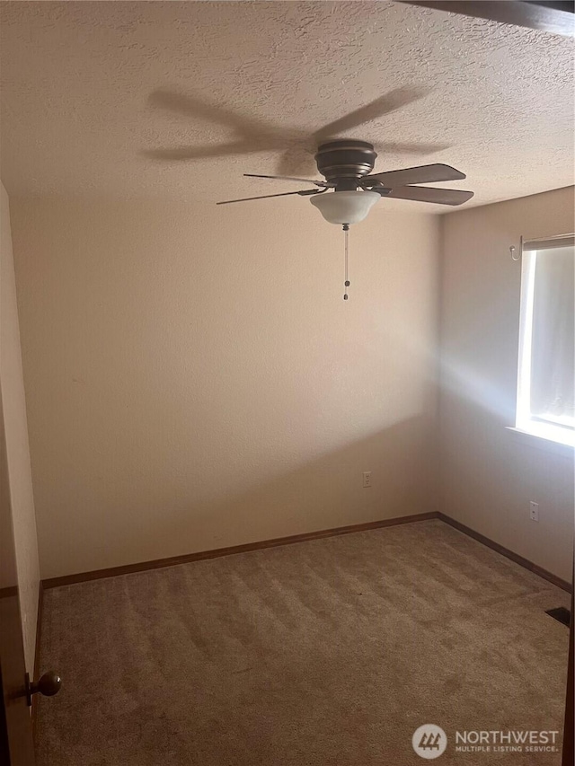 319 N Grape Dr, Moses Lake, WA 98837 - spare room featuring carpet flooring, ceiling fan, a textured ceiling, and baseboards