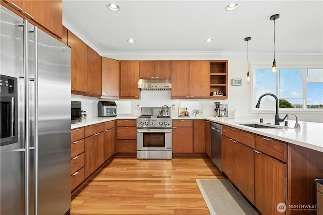 1109 30th Ave S, Seattle, WA 98144 - kitchen featuring high end appliances, a sink, ventilation hood, brown cabinets, and light wood finished floors