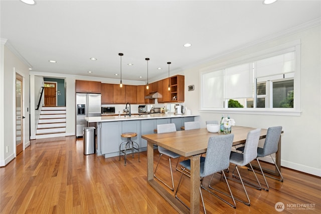 1109 30th Ave S, Seattle, WA 98144 - dining room with recessed lighting, crown molding, baseboards, light wood-type flooring, and stairs