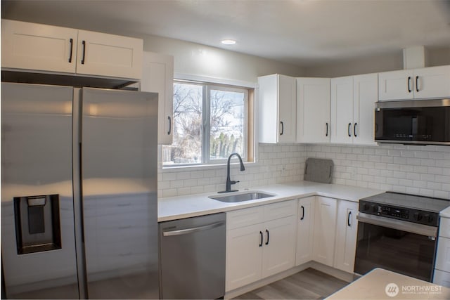 1001 Jacquelyn St, Milton-Freewater, OR 97862 - kitchen with stainless steel appliances, a sink, white cabinetry, light countertops, and recessed lighting