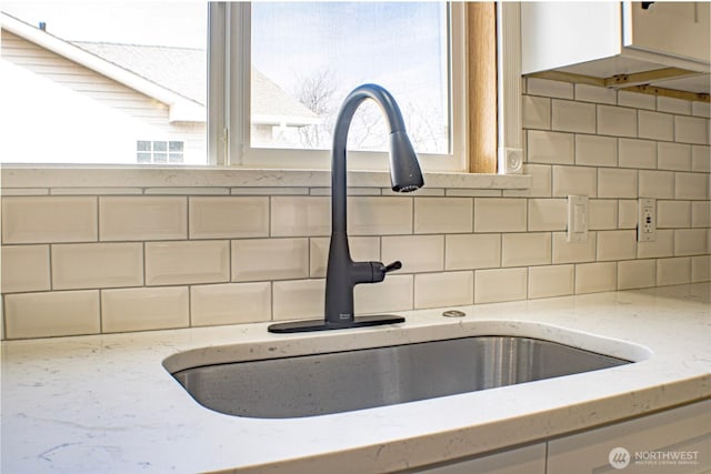 1001 Jacquelyn St, Milton-Freewater, OR 97862 - kitchen view of a sink, backsplash, and light stone countertops