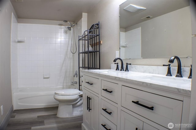 1001 Jacquelyn St, Milton-Freewater, OR 97862 - bathroom featuring wood finished floors, double vanity, shower / washtub combination, and toilet