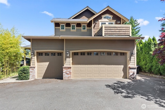 7301 NE 155th St, Kenmore, WA 98028 - craftsman-style house with a garage, asphalt driveway, and brick siding