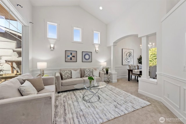 7301 NE 155th St, Kenmore, WA 98028 - living area with high vaulted ceiling, a decorative wall, healthy amount of natural light, arched walkways, and light colored carpet