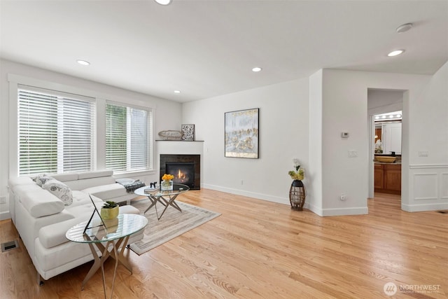 7301 NE 155th St, Kenmore, WA 98028 - living area featuring light wood-type flooring, recessed lighting, a glass covered fireplace, and baseboards