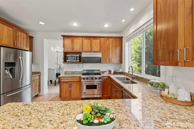7301 NE 155th St, Kenmore, WA 98028 - kitchen featuring appliances with stainless steel finishes, a sink, light stone countertops, and recessed lighting