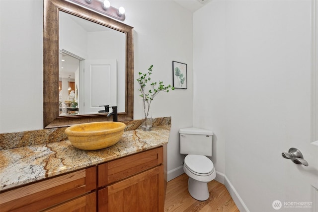 7301 NE 155th St, Kenmore, WA 98028 - bathroom with vanity, toilet, wood finished floors, and baseboards
