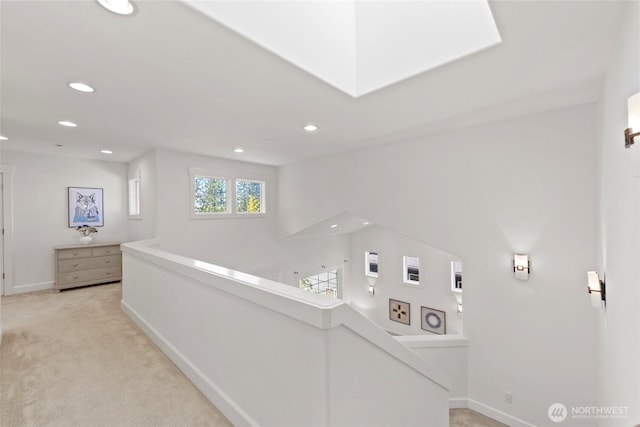 7301 NE 155th St, Kenmore, WA 98028 - hallway featuring recessed lighting, light colored carpet, baseboards, and a skylight