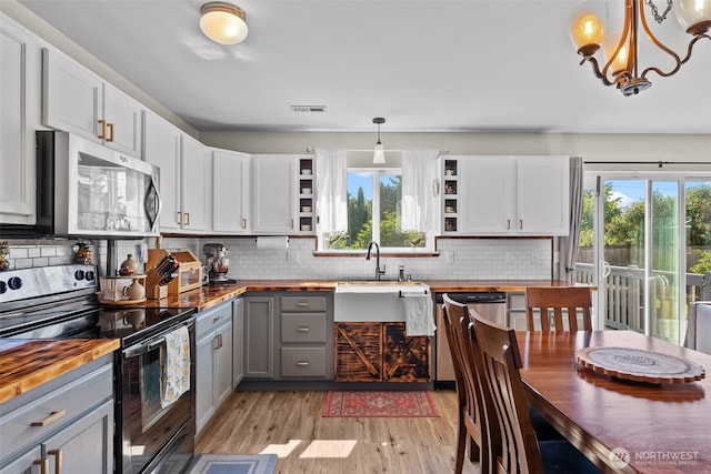 10096 Terra Glenn St SE, Yelm, WA 98597 - kitchen featuring wooden counters, appliances with stainless steel finishes, gray cabinetry, open shelves, and light wood-style floors