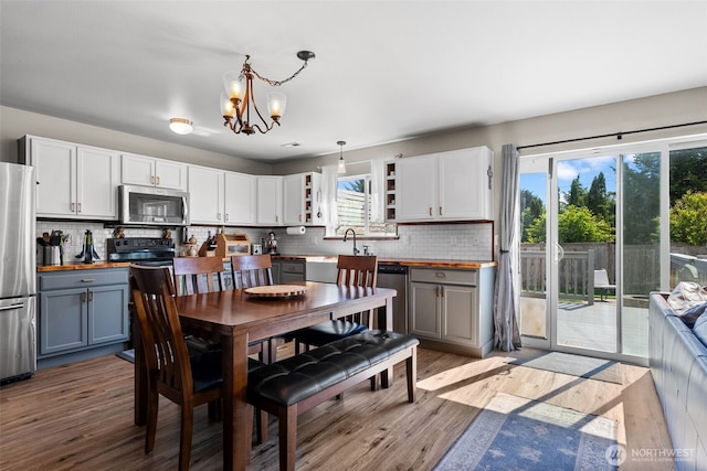 10096 Terra Glenn St SE, Yelm, WA 98597 - dining space featuring light wood-style floors and a chandelier