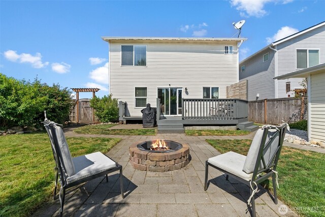 10096 Terra Glenn St SE, Yelm, WA 98597 - rear view of house featuring a fire pit, a patio area, and a wooden deck