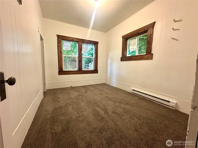 381 Trillium Ave, Forks, WA 98331 - empty room with baseboard heating, dark carpet, and healthy amount of natural light