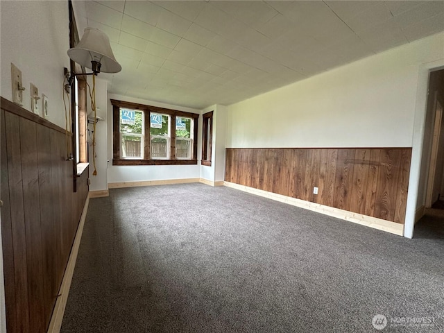 381 Trillium Ave, Forks, WA 98331 - empty room featuring wood walls, carpet flooring, and a wainscoted wall
