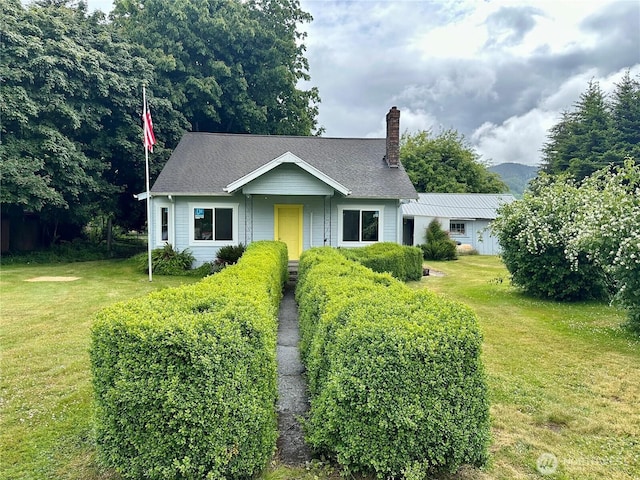 381 Trillium Ave, Forks, WA 98331 - view of front facade featuring a chimney, a front yard, and a shingled roof