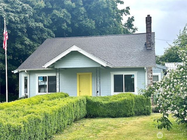 381 Trillium Ave, Forks, WA 98331 - view of front of property featuring a chimney, a front yard, and roof with shingles