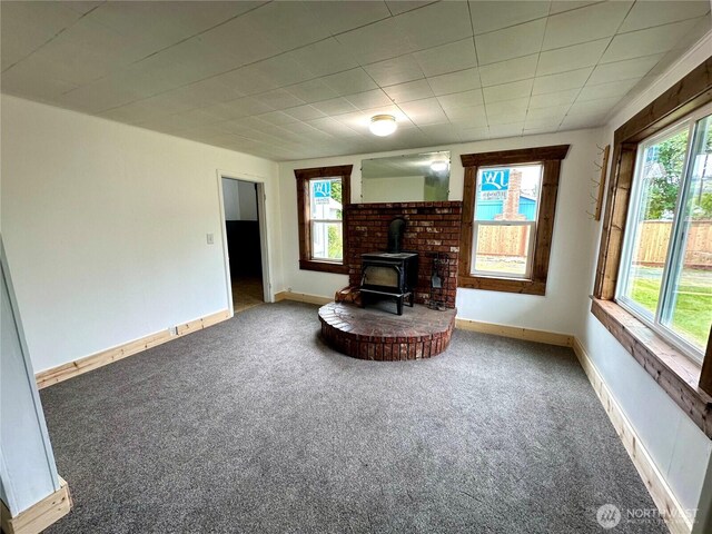 381 Trillium Ave, Forks, WA 98331 - carpeted living area with a wood stove and healthy amount of natural light