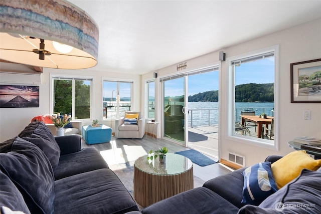 9451 E State Route 106, Union, WA 98592 - living area featuring a water view, wood finished floors, and healthy amount of natural light