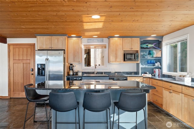 9451 E State Route 106, Union, WA 98592 - kitchen with appliances with stainless steel finishes, a sink, wooden ceiling, light brown cabinetry, and a kitchen breakfast bar