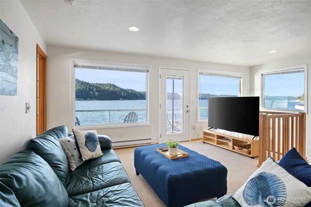 9451 E State Route 106, Union, WA 98592 - carpeted living room featuring a baseboard radiator, a textured ceiling, and recessed lighting