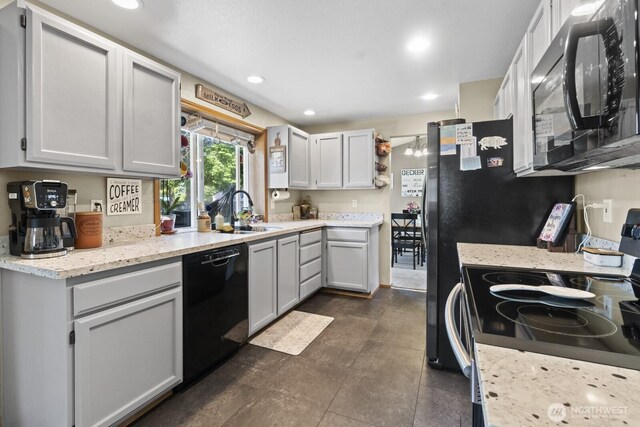 11420 232nd Avenue Ct E, Buckley, WA 98321 - kitchen featuring black appliances, a sink, recessed lighting, and light stone counters