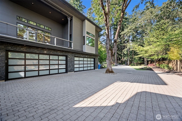 7708 Walnut St SW, Lakewood, WA 98498 - deck featuring an attached garage and decorative driveway