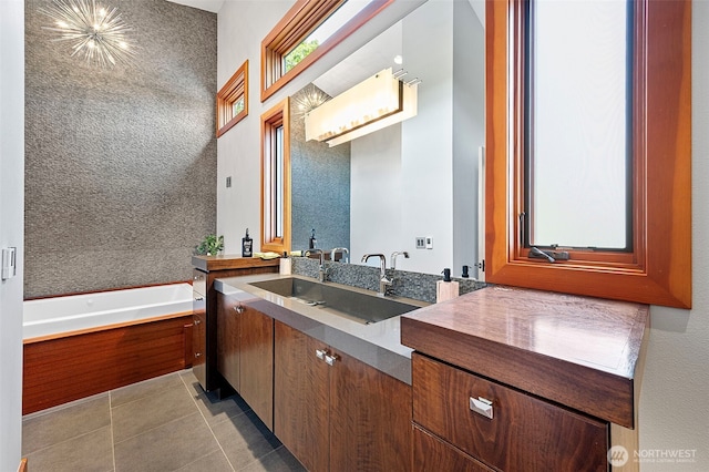 7708 Walnut St SW, Lakewood, WA 98498 - bathroom featuring vanity, a bath, and tile patterned floors