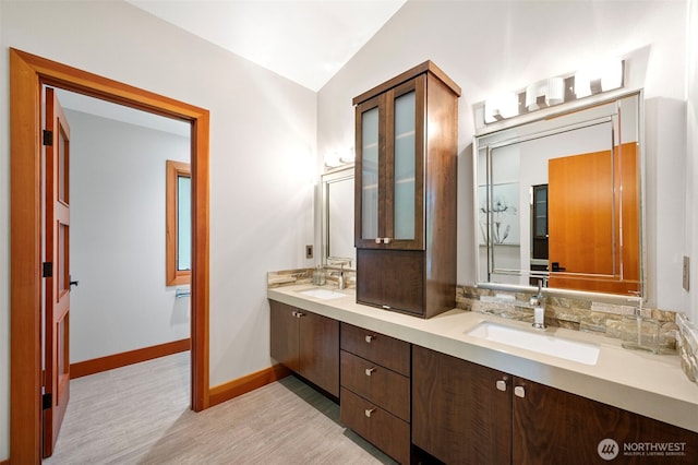 7708 Walnut St SW, Lakewood, WA 98498 - full bathroom featuring double vanity, wood finished floors, and vaulted ceiling