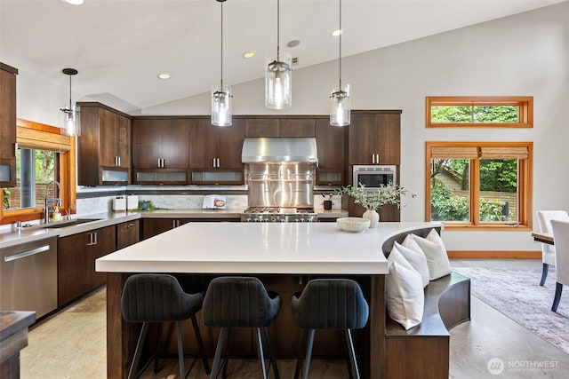 7708 Walnut St SW, Lakewood, WA 98498 - kitchen featuring ventilation hood, backsplash, light countertops, dark brown cabinetry, and recessed lighting