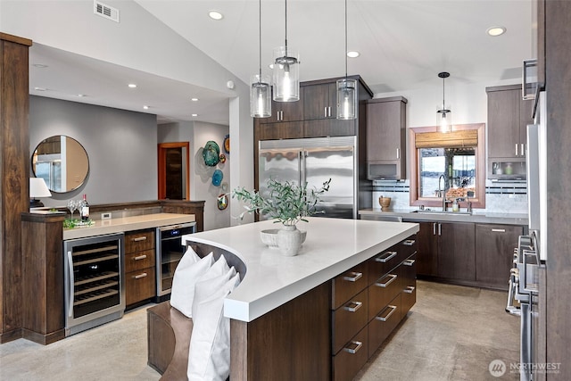 7708 Walnut St SW, Lakewood, WA 98498 - kitchen with beverage cooler, built in fridge, dark brown cabinetry, light countertops, and recessed lighting