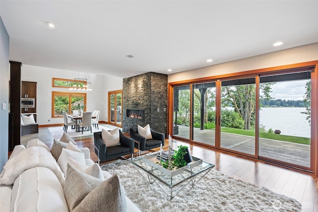 7708 Walnut St SW, Lakewood, WA 98498 - living area featuring wood finished floors, healthy amount of natural light, a fireplace, and recessed lighting