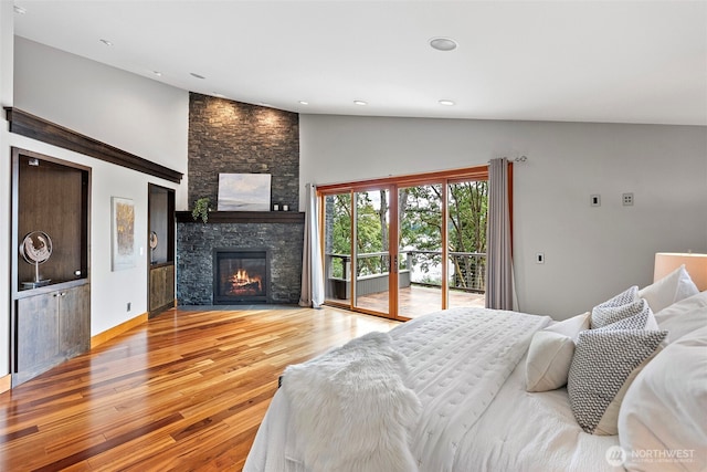 7708 Walnut St SW, Lakewood, WA 98498 - bedroom featuring access to exterior, wood finished floors, a fireplace, high vaulted ceiling, and recessed lighting