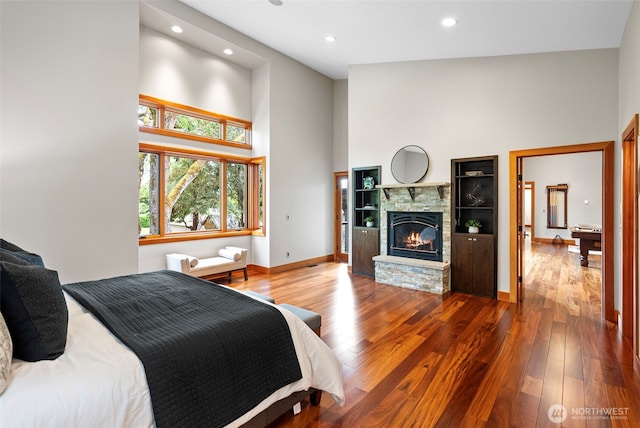 7708 Walnut St SW, Lakewood, WA 98498 - bedroom with a towering ceiling, wood finished floors, recessed lighting, and a stone fireplace