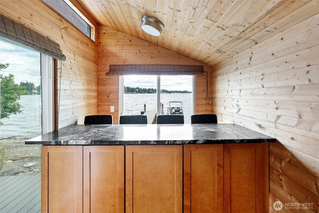 7708 Walnut St SW, Lakewood, WA 98498 - kitchen featuring wood walls, vaulted ceiling, dark stone counters, wooden ceiling, and a peninsula