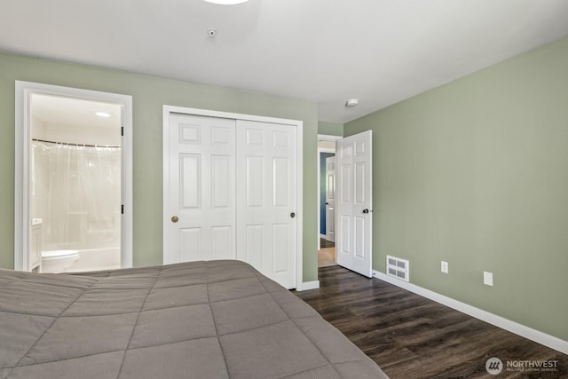 13629 26th Pl W Unit B104, Lynnwood, WA 98087 - unfurnished bedroom featuring dark wood-type flooring, a closet, baseboards, and ensuite bath