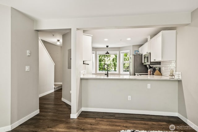 13629 26th Pl W Unit B104, Lynnwood, WA 98087 - kitchen featuring stainless steel appliances, white cabinets, baseboards, dark wood-style flooring, and recessed lighting