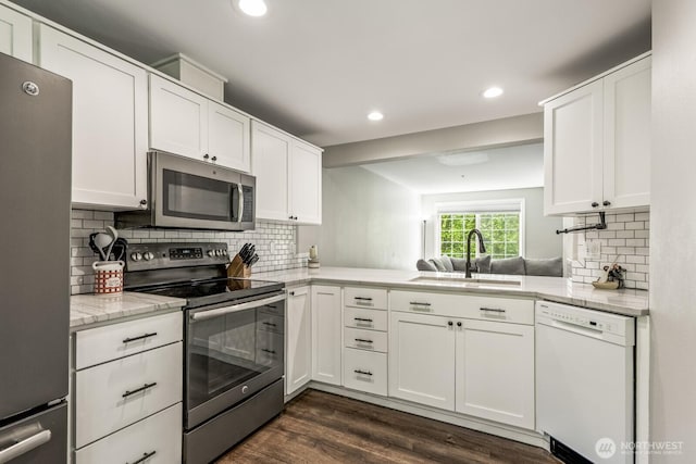 13629 26th Pl W Unit B104, Lynnwood, WA 98087 - kitchen with appliances with stainless steel finishes, a sink, white cabinets, recessed lighting, and backsplash
