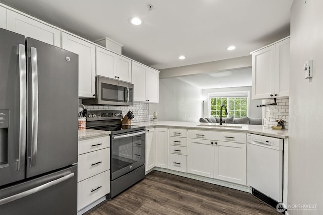 13629 26th Pl W Unit B104, Lynnwood, WA 98087 - kitchen with stainless steel appliances, a sink, tasteful backsplash, white cabinetry, and recessed lighting